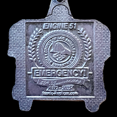 Metal badge with 'Engine 51' and 'Emergency!' text on a black background